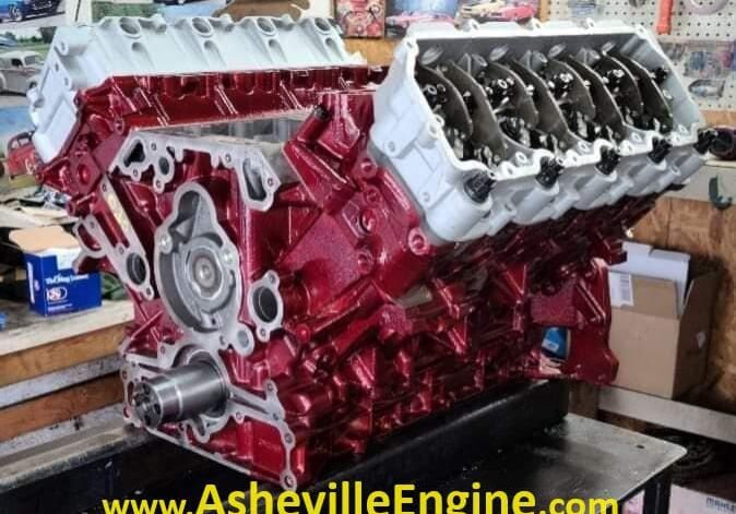Red engine block on workshop table.